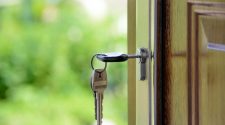 Keys inserted into a door lock, symbolising physical security and controlled access for a business or property.