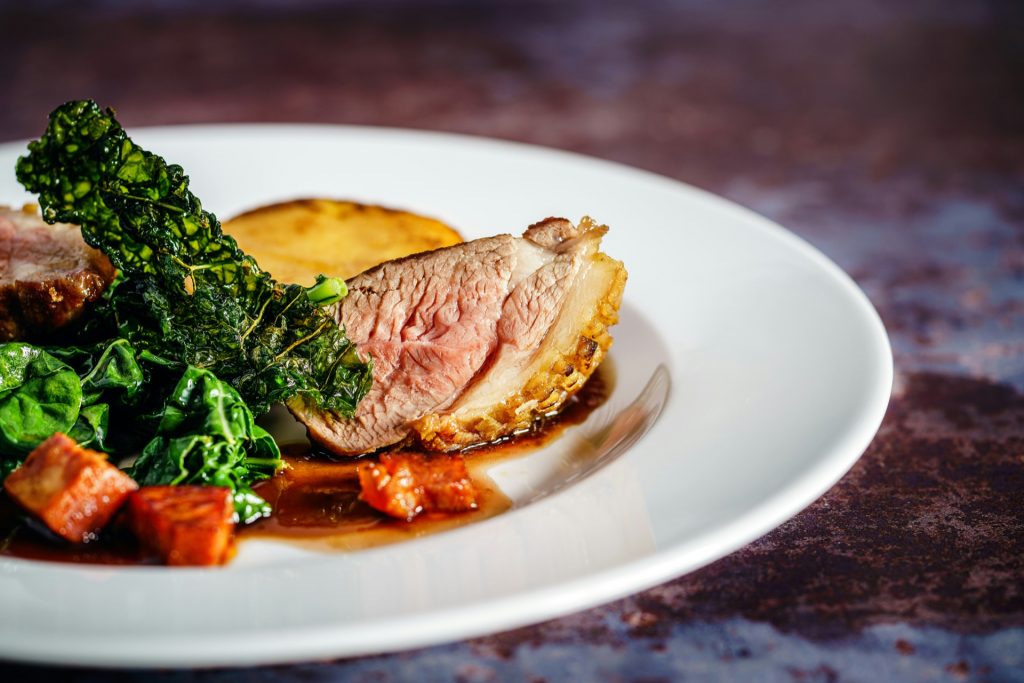 Sunday roast plate with sliced beef and greens for a Sunday roast vs Sunday carvery comparison